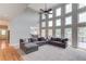 Grand living room featuring soaring ceilings, many windows, and modern gray sofas at 1608 Mulberry Lake Dr, Dacula, GA 30019