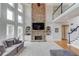 Bright, open-concept living room with a stone fireplace, built-ins, and a large TV at 1608 Mulberry Lake Dr, Dacula, GA 30019
