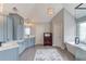 Large bathroom with double vanity, cabinets, standalone tub, and walk-in shower at 1608 Mulberry Lake Dr, Dacula, GA 30019