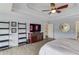 Stylish main bedroom with a trey ceiling, ceiling fan, media center and modern decor at 1608 Mulberry Lake Dr, Dacula, GA 30019