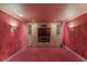 Spacious media room with a large built-in entertainment center and red walls offering a cozy viewing experience at 1608 Mulberry Lake Dr, Dacula, GA 30019