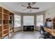 Well-lit office with a ceiling fan, built-in bookshelves, and a desk at 1608 Mulberry Lake Dr, Dacula, GA 30019