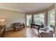 Cozy home office with hardwood floors, bright windows, and comfortable seating area at 1608 Mulberry Lake Dr, Dacula, GA 30019
