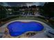 Aerial view of a backyard oasis featuring a sparkling blue pool, putting green, and lake views at 1608 Mulberry Lake Dr, Dacula, GA 30019