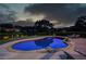 Inviting in-ground pool and putting green surrounded by landscaped backyard at twilight at 1608 Mulberry Lake Dr, Dacula, GA 30019