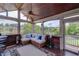 Relaxing screened-in porch overlooking the lake with comfortable seating, ceiling fan, and beautiful views at 1608 Mulberry Lake Dr, Dacula, GA 30019