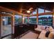 Inviting sunroom with wood paneled ceiling, fan, and windows overlooking a picturesque lake and neighborhood at 1608 Mulberry Lake Dr, Dacula, GA 30019