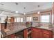Kitchen wet bar with granite countertop, tile backsplash, custom cabinets, stainless steel appliances and a wine cooler at 1608 Mulberry Lake Dr, Dacula, GA 30019