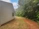 Exterior view of the home showcasing a spacious backyard, mature trees, and white siding at 3146 Leyland Ct, Decatur, GA 30034