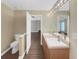 Well-lit bathroom with double sinks, wood-grain floors, and an adjacent toilet room at 3146 Leyland Ct, Decatur, GA 30034