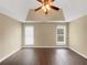 Spacious bedroom featuring hardwood floors, neutral paint, tray ceiling, and a ceiling fan at 3146 Leyland Ct, Decatur, GA 30034