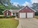Charming brick home with a well-maintained front yard and a two-car garage at 3146 Leyland Ct, Decatur, GA 30034
