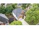 Aerial view of brick house with mature trees, paved driveway, and manicured lawn at 315 Hembree Grove Trce, Roswell, GA 30076