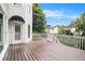 The back of the home features a spacious wooden deck overlooking mature landscaping at 315 Hembree Grove Trce, Roswell, GA 30076