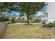 Expansive backyard features a mix of grass, mature trees, and landscaped features at 315 Hembree Grove Trce, Roswell, GA 30076