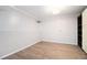 Clean basement featuring wood-look flooring, white brick walls, and built-in storage at 315 Hembree Grove Trce, Roswell, GA 30076