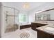 Bright bathroom featuring double vanities, soaking tub, and glass enclosed shower at 315 Hembree Grove Trce, Roswell, GA 30076