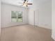 Bedroom featuring neutral carpet, ceiling fan and a window with green lawn view at 315 Hembree Grove Trce, Roswell, GA 30076