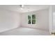 Bedroom showcasing a bright window and neutral carpeting at 315 Hembree Grove Trce, Roswell, GA 30076