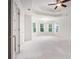 Bright bedroom featuring tray ceiling, ceiling fan, neutral carpet, and several windows at 315 Hembree Grove Trce, Roswell, GA 30076