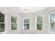 Bright bedroom featuring white trim and several windows with green lawn view at 315 Hembree Grove Trce, Roswell, GA 30076