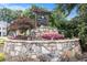 Stone entrance sign for Hembee Grove surrounded by colorful flowers and greenery at 315 Hembree Grove Trce, Roswell, GA 30076