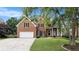 Beautiful brick home with mature trees, paved driveway, and manicured lawn at 315 Hembree Grove Trce, Roswell, GA 30076