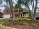 Beautiful brick home with mature trees, landscaping and a classic architectural style at 315 Hembree Grove Trce, Roswell, GA 30076