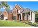 Elegant brick home with a two-car garage, manicured lawn, and inviting front entrance at 315 Hembree Grove Trce, Roswell, GA 30076