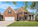 Attractive brick home with a well-maintained lawn, garage, and inviting entrance at 315 Hembree Grove Trce, Roswell, GA 30076