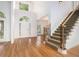 Bright foyer featuring hardwood floors, a grand staircase, and a front door with sidelights at 315 Hembree Grove Trce, Roswell, GA 30076