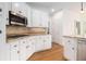 Kitchen with white cabinets, stainless steel appliances, hardwood floors, and granite countertops at 315 Hembree Grove Trce, Roswell, GA 30076