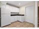 Kitchenette with abundant cabinets, sink, and stairs leading to another floor at 315 Hembree Grove Trce, Roswell, GA 30076