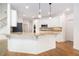 Bright, open kitchen with granite countertops, white cabinetry, and stainless steel appliances at 315 Hembree Grove Trce, Roswell, GA 30076