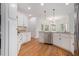 Kitchen with white cabinets, stainless steel appliances, hardwood floors, and granite countertops at 315 Hembree Grove Trce, Roswell, GA 30076