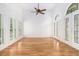 Bright living room with hardwood floors, tall ceilings and large windows with white shutters at 315 Hembree Grove Trce, Roswell, GA 30076