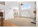 Bright, open living room with large windows, shutters, stone fireplace, and soaring ceilings at 315 Hembree Grove Trce, Roswell, GA 30076