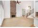Spacious living room featuring a floor-to-ceiling stone fireplace, hardwood floors, and large windows at 315 Hembree Grove Trce, Roswell, GA 30076