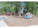 Community playground with slides and a train play structure surrounded by mature trees at 315 Hembree Grove Trce, Roswell, GA 30076