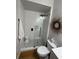Bathroom featuring a tiled walk-in shower, modern fixtures, and an eye-catching wreath decoration at 6725 Grove Meadows Ln, Cumming, GA 30028