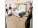Comfortable bedroom with stylish guitar decor, natural light, and a wooden headboard at 6725 Grove Meadows Ln, Cumming, GA 30028