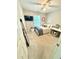 Cozy bedroom featuring a ceiling fan, full-length mirror, and large window for natural light at 6725 Grove Meadows Ln, Cumming, GA 30028