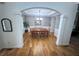 Spacious dining room with hardwood floors, decorative molding, and an elegant chandelier at 6725 Grove Meadows Ln, Cumming, GA 30028
