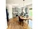 This kitchen has granite countertops, stainless steel appliances, light grey cabinets, and hardwood floors at 6725 Grove Meadows Ln, Cumming, GA 30028