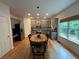 Spacious kitchen featuring gray cabinets, stainless steel appliances, hardwood floors, and an eat-in breakfast nook at 6725 Grove Meadows Ln, Cumming, GA 30028