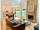 Open concept living area with hardwood floors, stone fireplace, and a modern kitchen at 6725 Grove Meadows Ln, Cumming, GA 30028