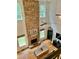 Comfortable living room with a stone fireplace, hardwood floors, and a ceiling fan at 6725 Grove Meadows Ln, Cumming, GA 30028