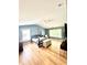 Spacious main bedroom with hardwood floors, multiple windows, a four-poster bed, and ample natural light at 6725 Grove Meadows Ln, Cumming, GA 30028