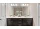 Bathroom showcasing double vanity sinks, dark wood cabinets, and bright lighting at 1914 Forte Ln, Alpharetta, GA 30009