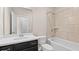 Bathroom featuring a sleek vanity with a dark wood finish and shower with tiled walls, offering modern comfort at 1914 Forte Ln, Alpharetta, GA 30009